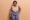Overweight dark skinned curly woman with big fat stomach holds weight wants to loose weight dressed