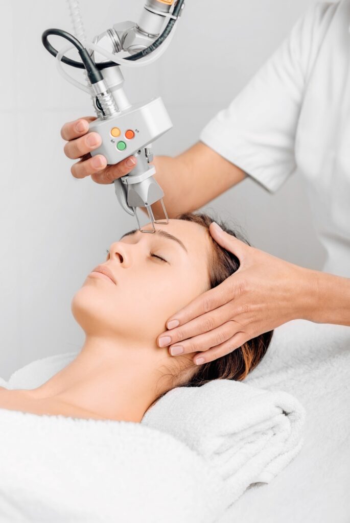 woman getting laser facial treatment, aesthetic surgery,