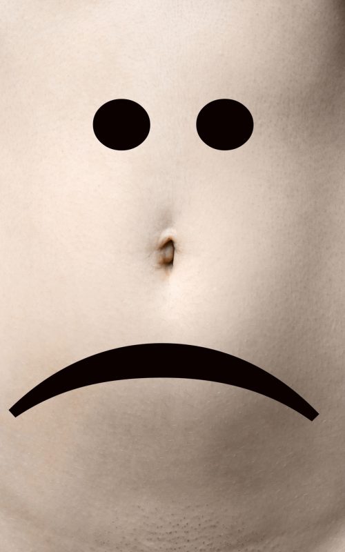 female belly or stomach with sad smiley face female belly or stomach with sad smiley face